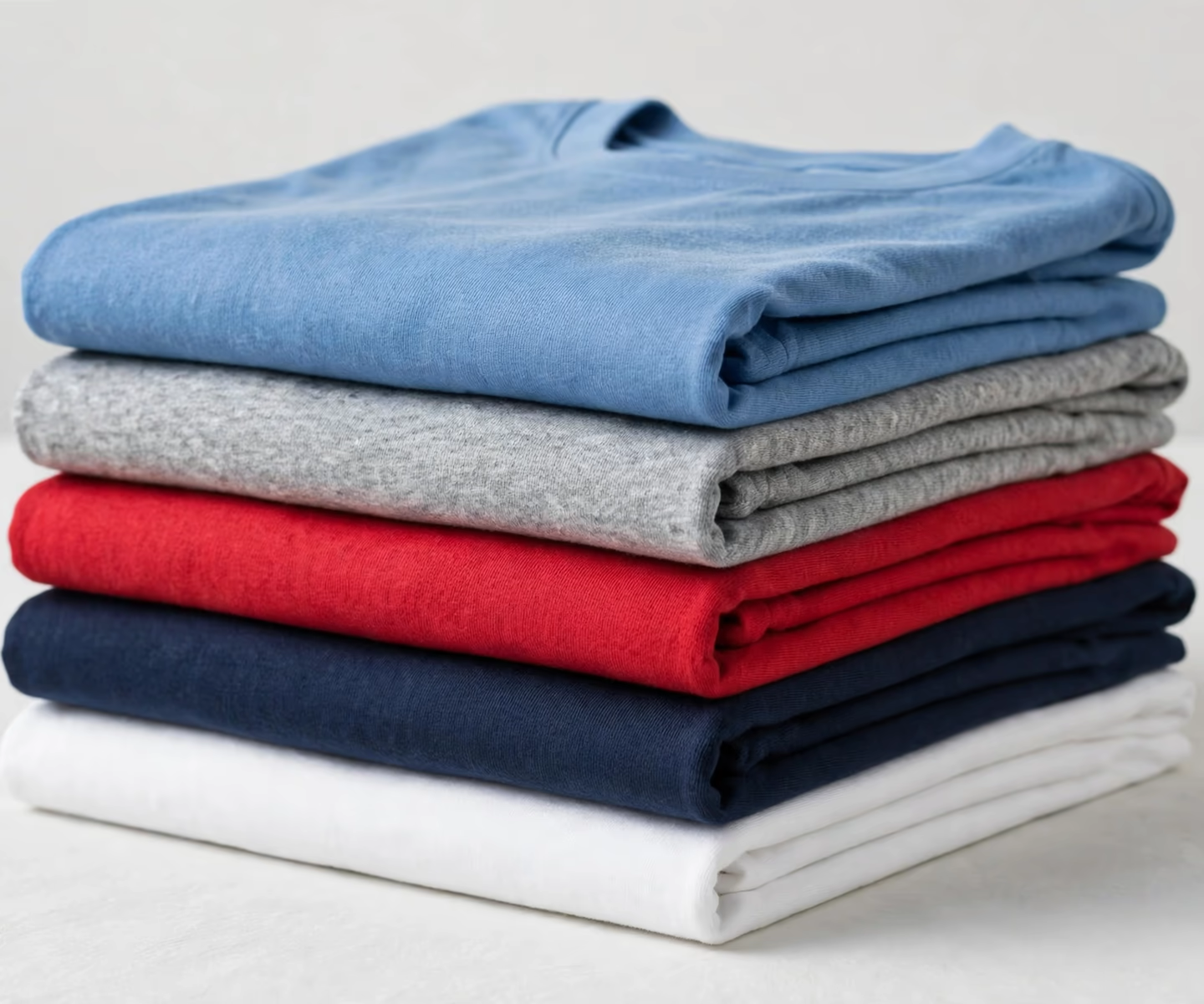 Folded blank t-shirts in assorted colours